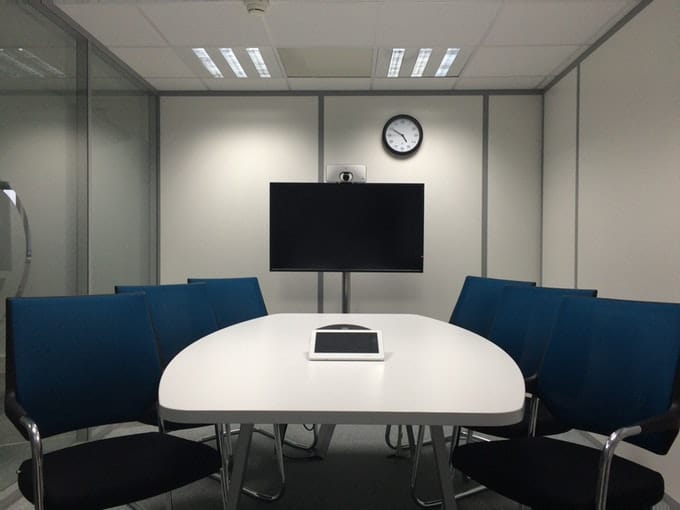 Chairs located around a table in a conference room
